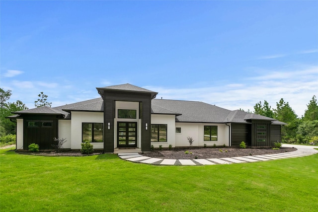 back of property featuring stucco siding, a shingled roof, french doors, and a yard