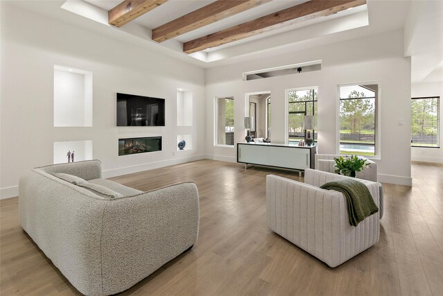 living room with beam ceiling and light hardwood / wood-style flooring