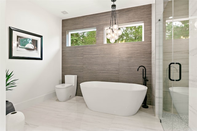 bathroom featuring separate shower and tub, plenty of natural light, and tile walls