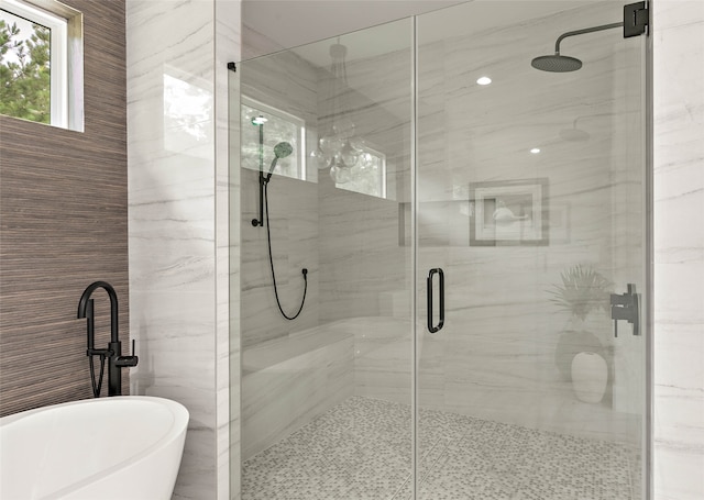 bathroom featuring shower with separate bathtub