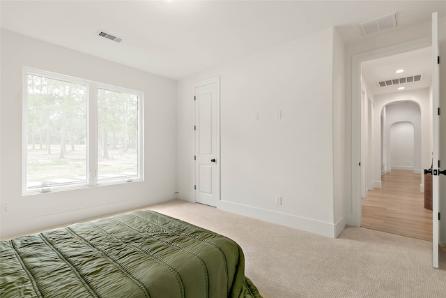 bedroom featuring light carpet