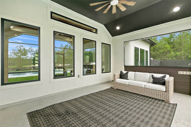 unfurnished sunroom featuring ceiling fan, a water view, and lofted ceiling