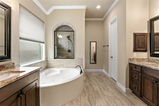 bathroom featuring plus walk in shower, vanity, and ornamental molding