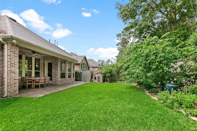 view of yard featuring ceiling fan and a patio area