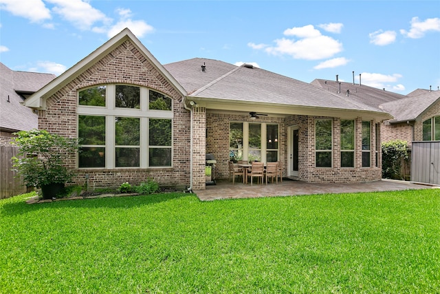 back of house with a patio area, ceiling fan, and a yard