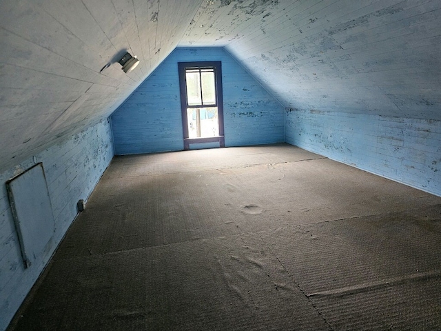 additional living space featuring lofted ceiling