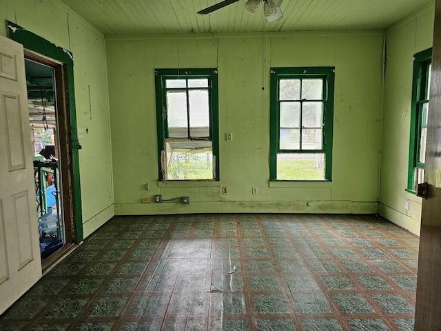 empty room with a wealth of natural light and ceiling fan