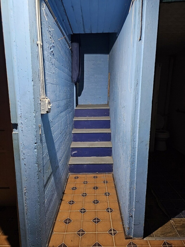 stairs featuring tile patterned floors