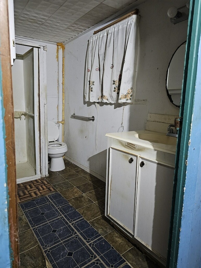 bathroom featuring toilet and vanity