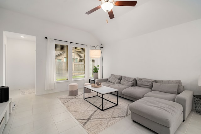 living room with ceiling fan, light tile patterned flooring, and vaulted ceiling