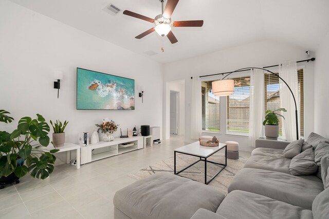 living room with light tile patterned floors, ceiling fan, and lofted ceiling