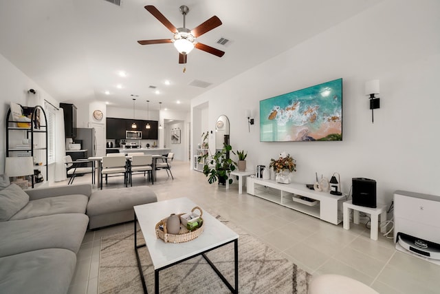 living room featuring light tile patterned floors and ceiling fan