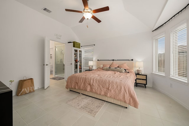 tiled bedroom with connected bathroom, ceiling fan, and lofted ceiling