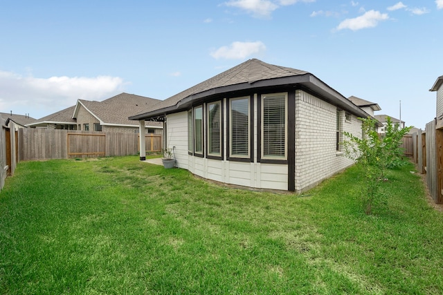 rear view of house with a lawn