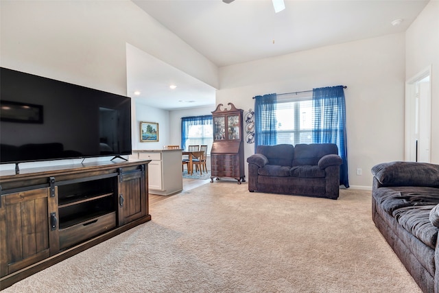 living room featuring light carpet and ceiling fan