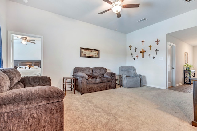 living room featuring carpet and ceiling fan