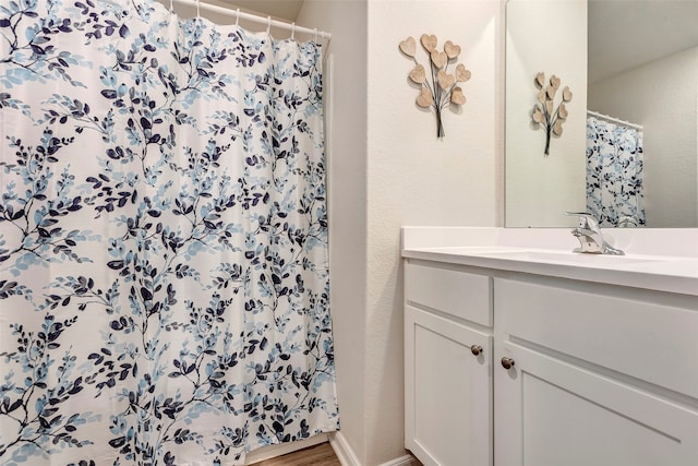 bathroom with vanity, wood-type flooring, and curtained shower