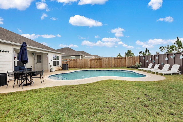 view of swimming pool with cooling unit, a lawn, and a patio