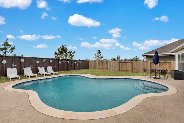 view of pool featuring a patio area and a yard