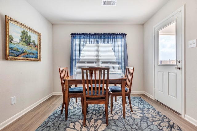 dining space with a wealth of natural light and light wood-type flooring