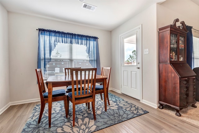 dining area with plenty of natural light and light wood-type flooring