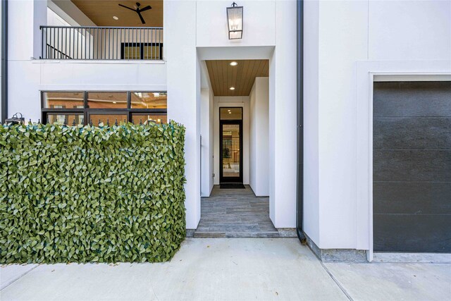 view of exterior entry featuring a balcony