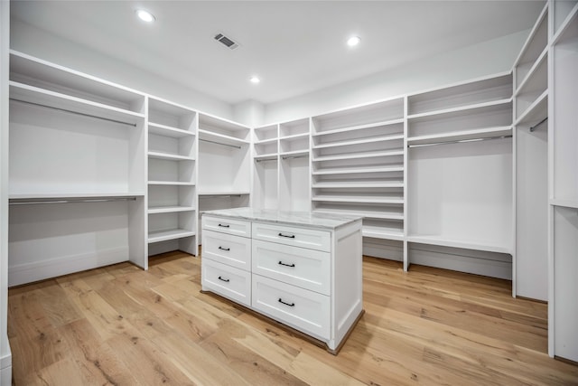 spacious closet featuring light hardwood / wood-style floors