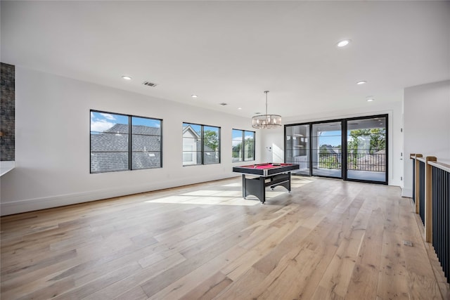 rec room with an inviting chandelier, pool table, and light hardwood / wood-style flooring