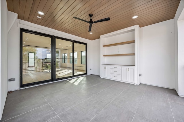 unfurnished living room with wooden ceiling, ceiling fan, and expansive windows