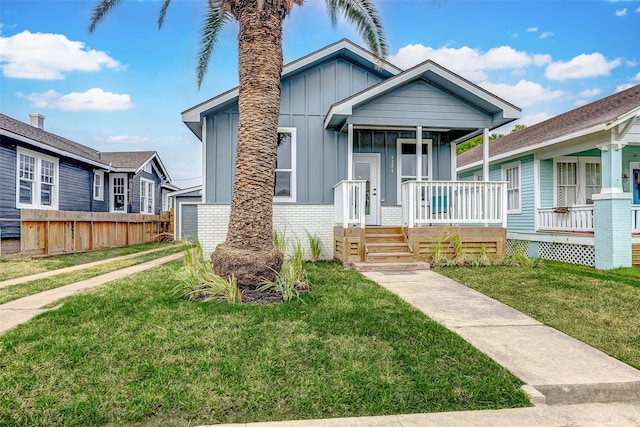 bungalow-style home with a porch and a front lawn