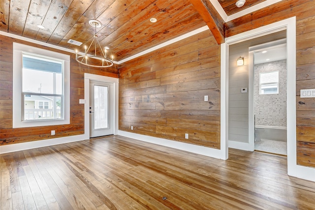 unfurnished room featuring a wealth of natural light, wood-type flooring, and wood ceiling