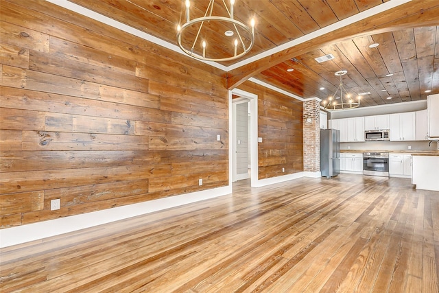 1324 Ursuline St, Galveston, TX 77550 - unfurnished living room featuring a chandelier, wooden ceiling, light wood-style floors, wooden walls, and baseboards