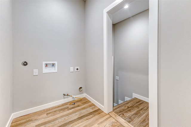 clothes washing area with gas dryer hookup, wood-type flooring, washer hookup, and hookup for an electric dryer