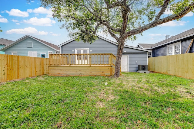 view of yard featuring central air condition unit and a wooden deck