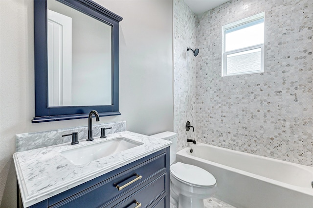 full bathroom featuring vanity, toilet, and tiled shower / bath