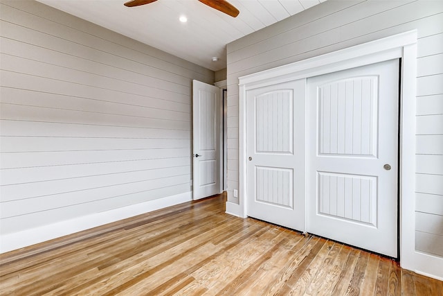 1324 Ursuline St, Galveston, TX 77550 - unfurnished bedroom featuring wooden walls, light wood finished floors, a closet, recessed lighting, and a ceiling fan