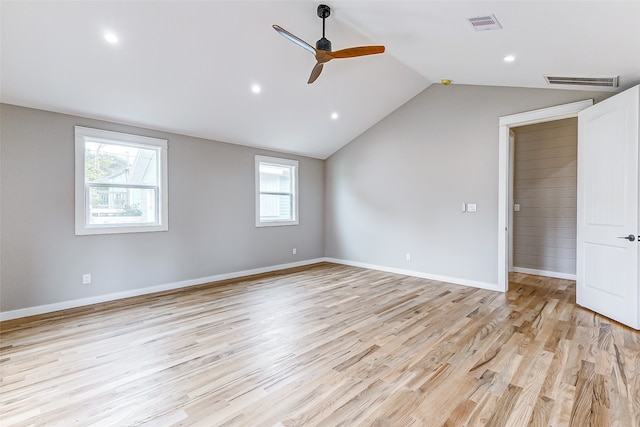 empty room featuring light hardwood / wood-style floors, ceiling fan, and vaulted ceiling