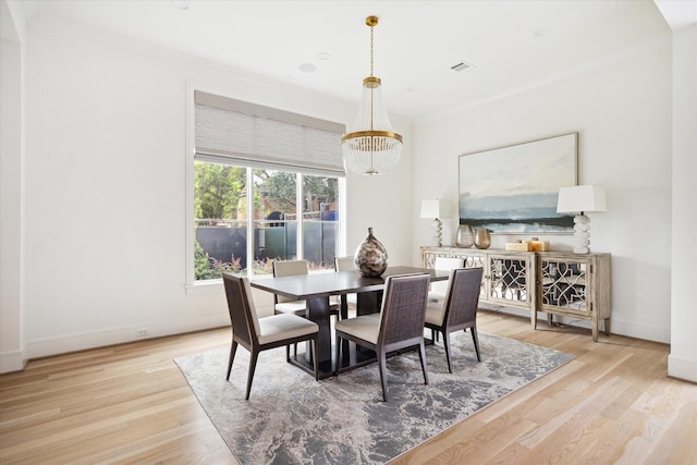 dining area with a notable chandelier and light wood-type flooring