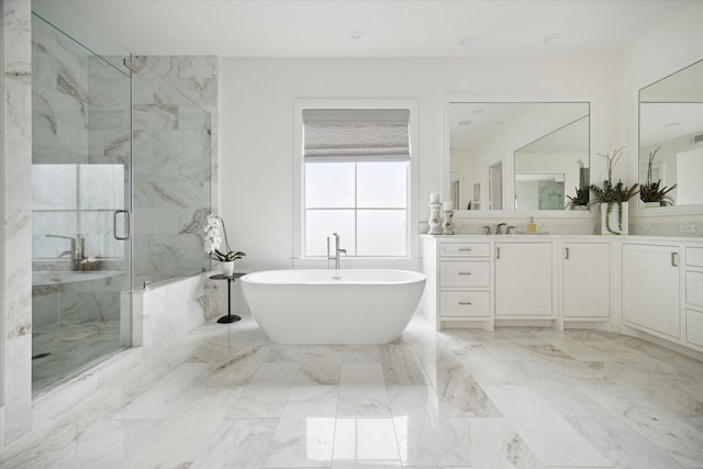 bathroom featuring vanity and independent shower and bath