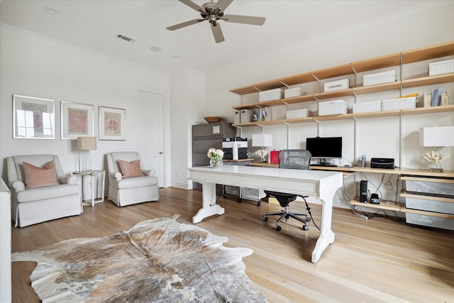 office with ceiling fan, crown molding, and light hardwood / wood-style flooring