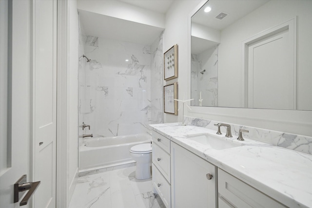 full bathroom with vanity, tiled shower / bath combo, and toilet