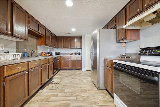 kitchen with light hardwood / wood-style floors, electric stove, black dishwasher, a textured ceiling, and sink