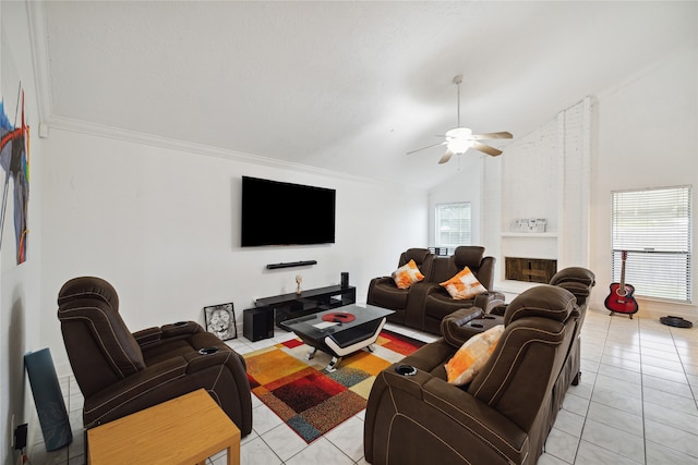 tiled living room with high vaulted ceiling, crown molding, ceiling fan, and a fireplace