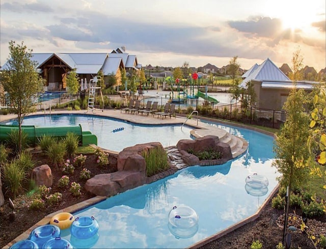 view of pool at dusk