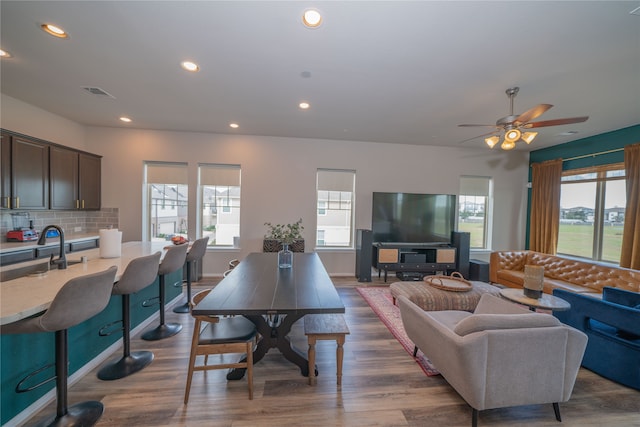 dining area with a wealth of natural light, sink, and dark hardwood / wood-style flooring