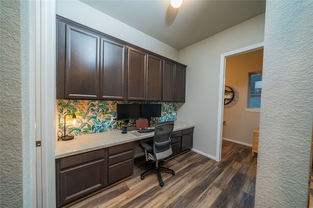 home office featuring dark wood-type flooring and built in desk