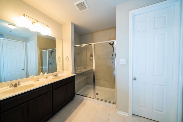 bathroom featuring vanity, walk in shower, and tile patterned floors