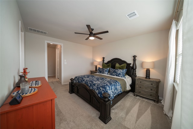 bedroom featuring multiple windows, light carpet, and ceiling fan