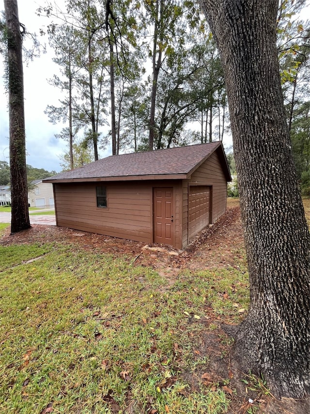 view of outdoor structure featuring a garage and a yard