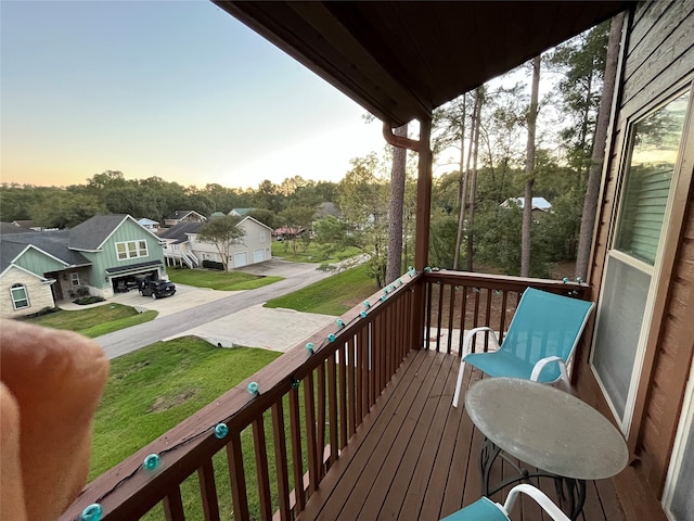 deck at dusk featuring a yard